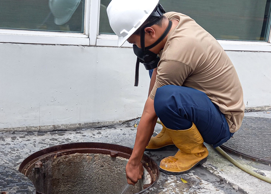 Man working within a sewer system