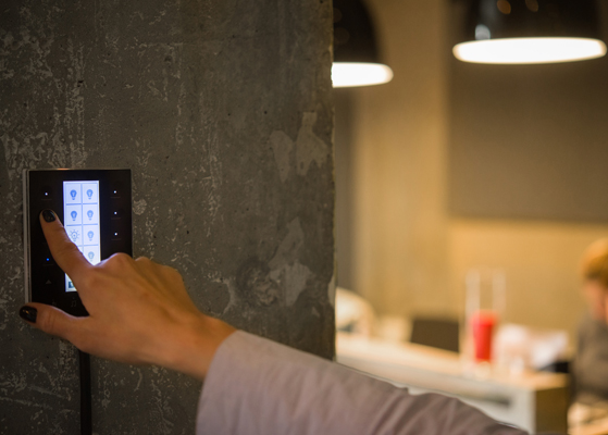 Person selecting options on a building control system monitor.